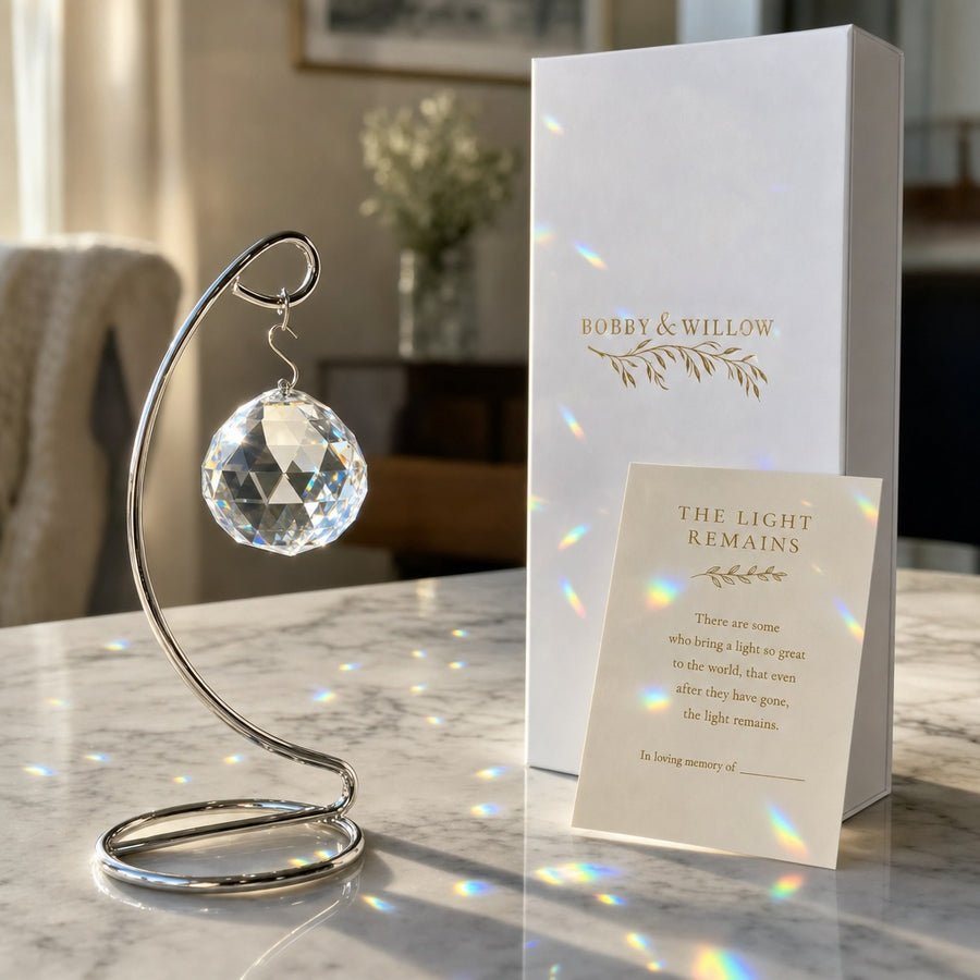 The Light Remains Tabletop: a 40mm faceted crystal on its stand, throwing rainbows