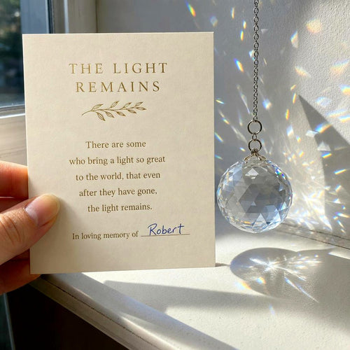 The poem card with Robert written by hand on the last line, beside the crystal in a sunny window